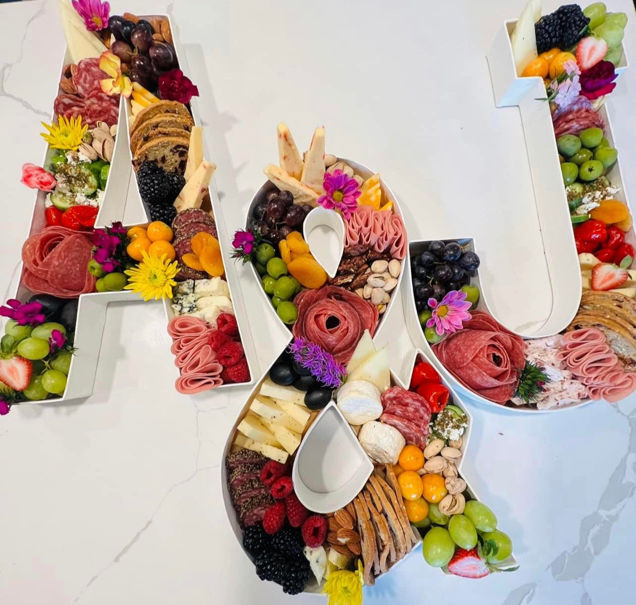 Letters in fruit and charcuterie vegetables